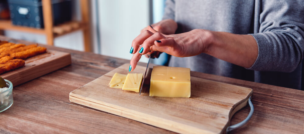 Hands slicing cheese - flawless skin