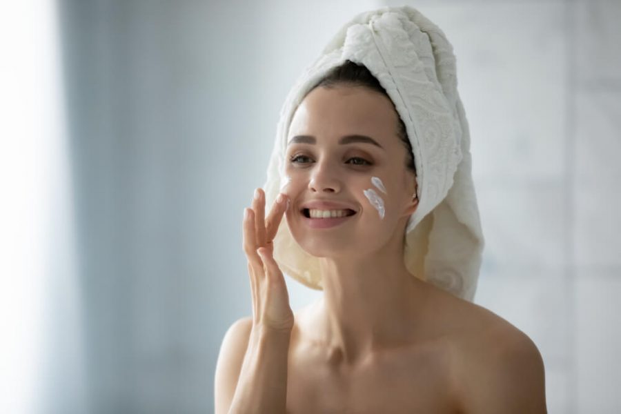 Woman applying face cream