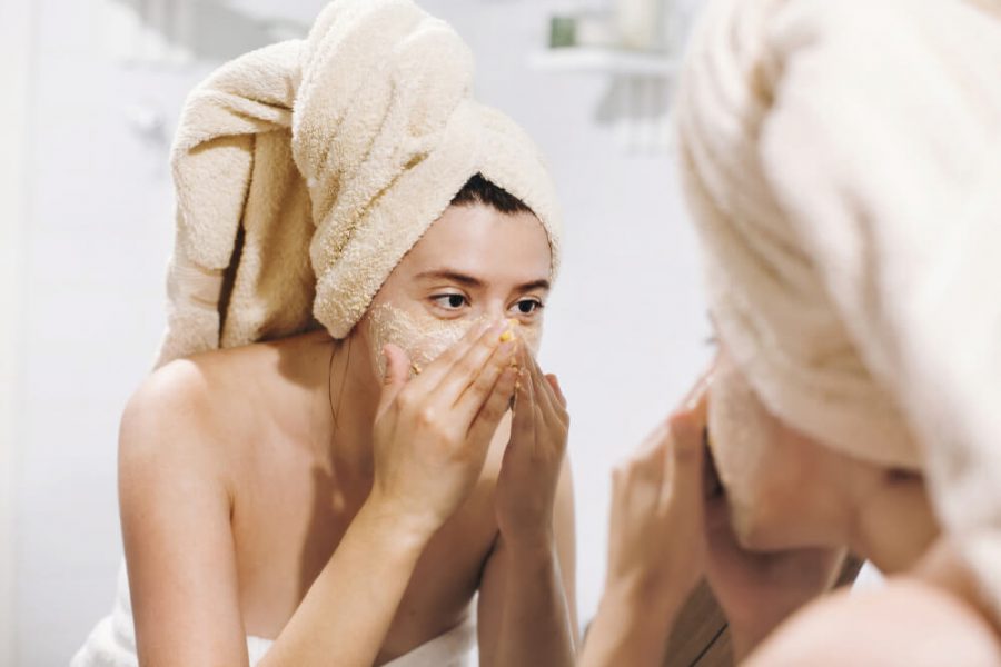 Woman exfoliating face