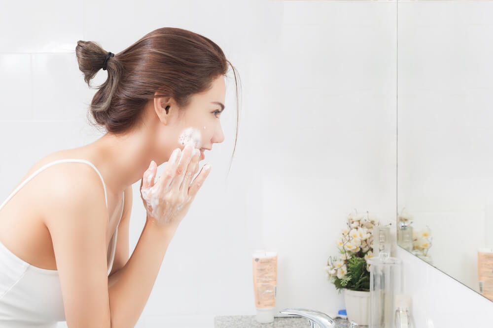 Woman cleansing skin