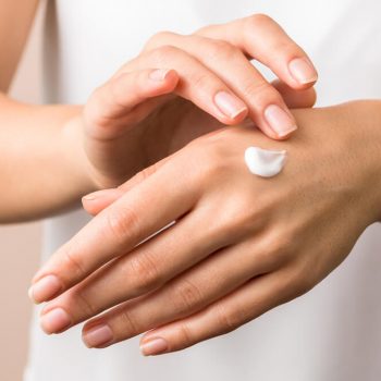 Woman applying hand cream