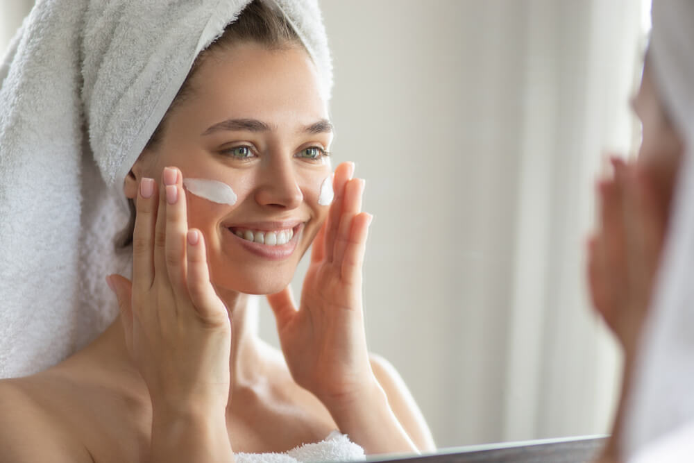 Woman applying face cream in winter skincare routine