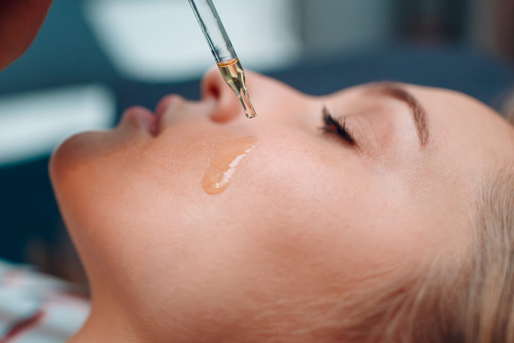 Woman applying face oil