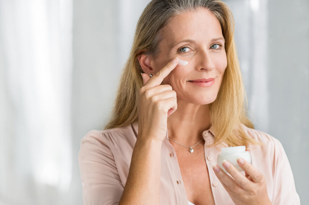 Woman keeping skin moisturized