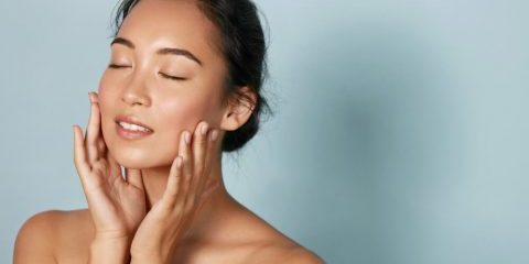 woman holding her face