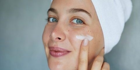 woman applying moisturizer